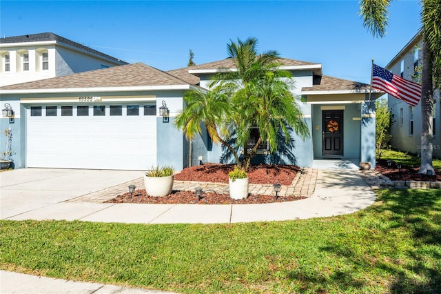 view of front facade featuring a garage and a front lawn