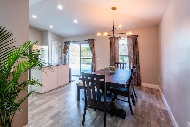 dining room featuring hardwood / wood-style floors and a notable chandelier