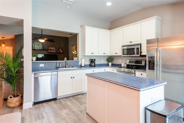 kitchen featuring white cabinets, sink, ceiling fan, light hardwood / wood-style floors, and stainless steel appliances