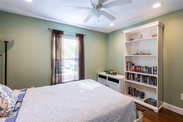 bedroom with ceiling fan and dark hardwood / wood-style floors