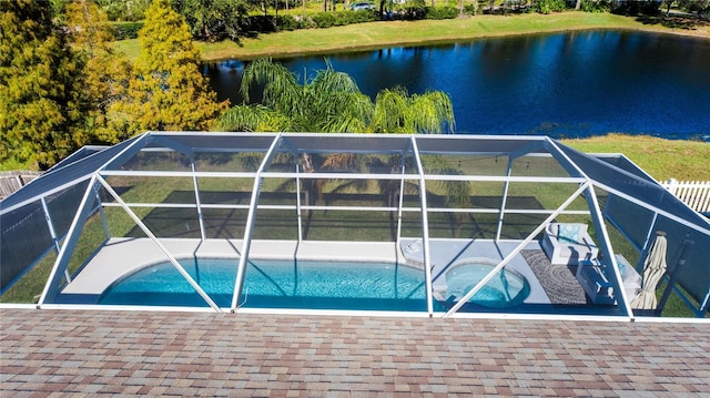 view of swimming pool with glass enclosure and a water view