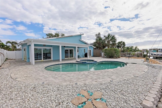 view of pool with an in ground hot tub and a patio area