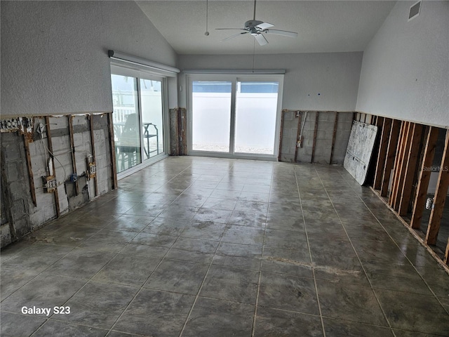 unfurnished room featuring ceiling fan and lofted ceiling