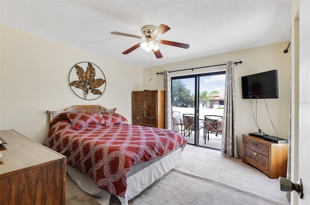 bedroom featuring a textured ceiling, ceiling fan, light carpet, and access to outside