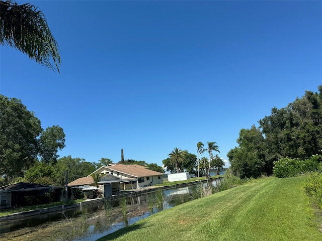 exterior space with a lawn and a water view