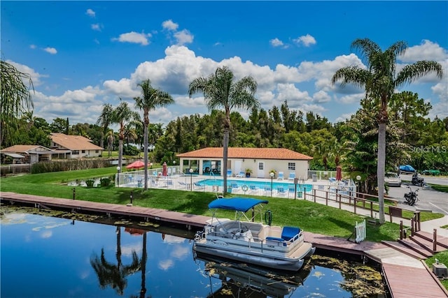 dock area featuring a water view, a yard, and a community pool