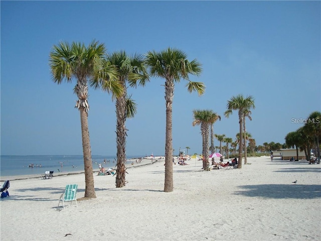 view of community with a beach view and a water view