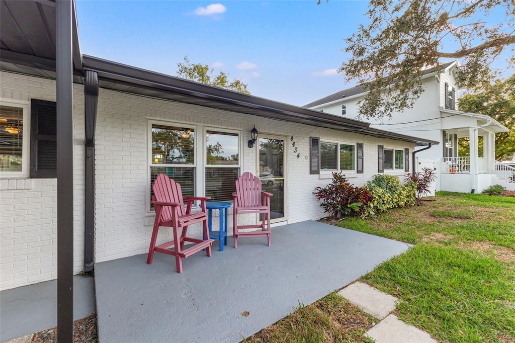 exterior space with a porch, a patio, and a lawn