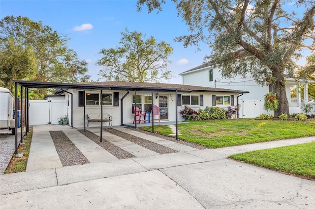 view of front of property with a carport, a porch, and a front lawn