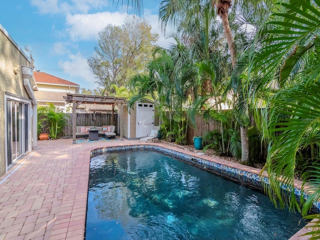 view of swimming pool featuring a pergola, outdoor lounge area, a patio, and a storage unit