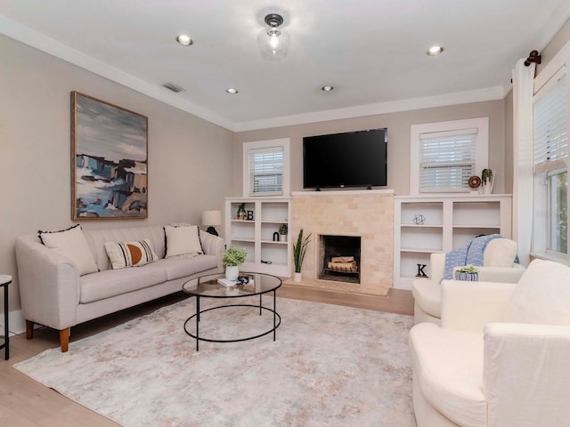 living room featuring ornamental molding and light hardwood / wood-style flooring