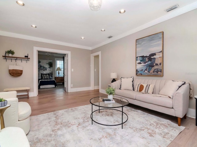 living room featuring crown molding and hardwood / wood-style floors