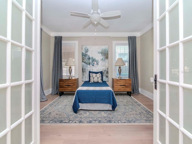 bedroom with crown molding and light wood-type flooring