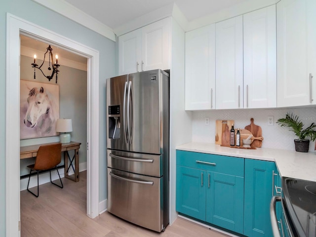 kitchen featuring electric stove, stainless steel fridge, light hardwood / wood-style flooring, white cabinets, and blue cabinets