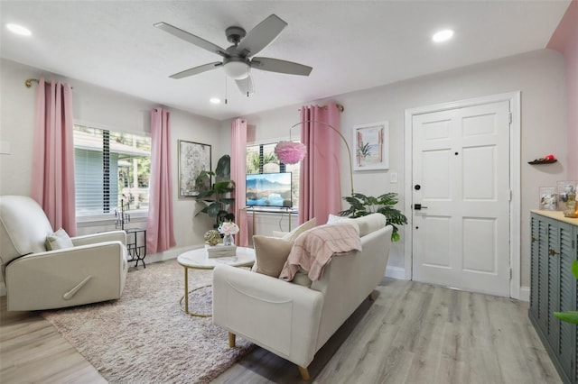 living room with ceiling fan and light hardwood / wood-style floors