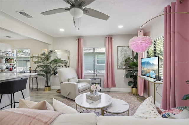 living room featuring ceiling fan and light hardwood / wood-style flooring