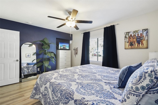 bedroom with ceiling fan and light hardwood / wood-style floors