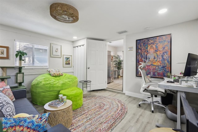 office with light hardwood / wood-style flooring