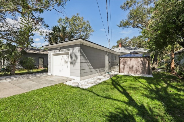 back of property with a yard, an outbuilding, and a garage