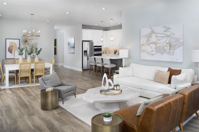 living room with a chandelier and hardwood / wood-style flooring