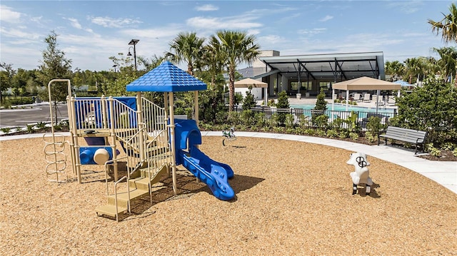 view of playground with a community pool