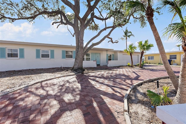 rear view of property featuring a garage