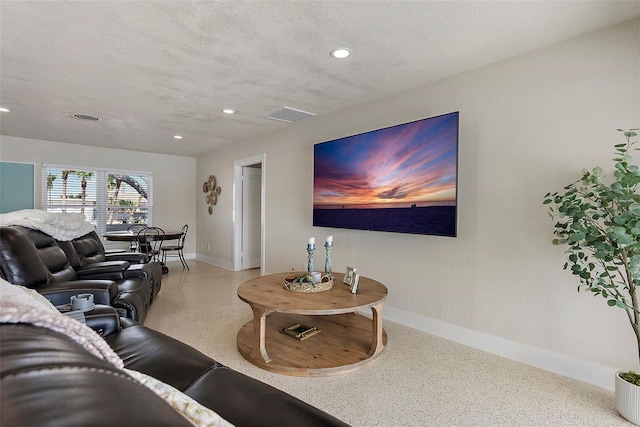 living room featuring a textured ceiling