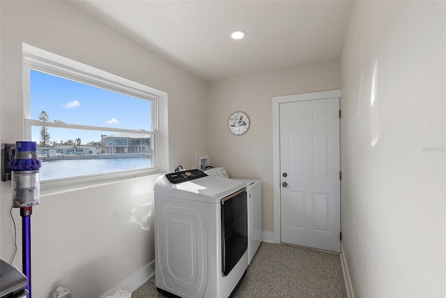 laundry area with a water view and separate washer and dryer