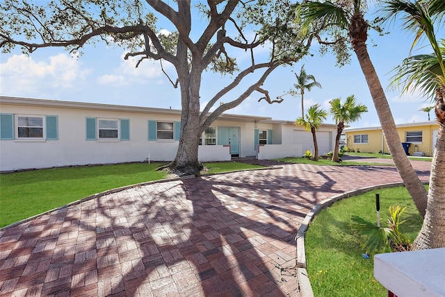 view of front of home with a garage and a front lawn