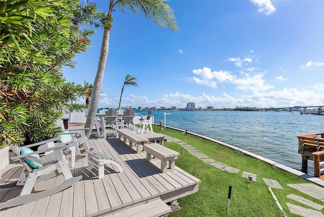 dock area with a water view and a lawn