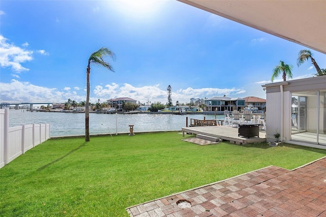 view of yard featuring a water view and a dock