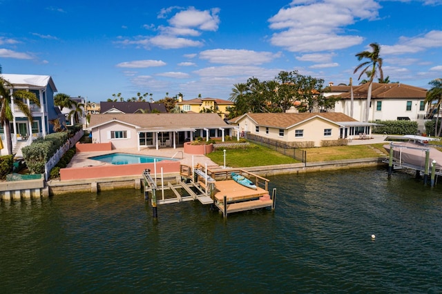 dock area with a lawn, a water view, and a patio