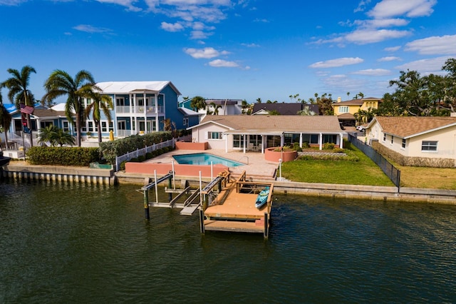 rear view of property featuring a yard, a patio, and a water view