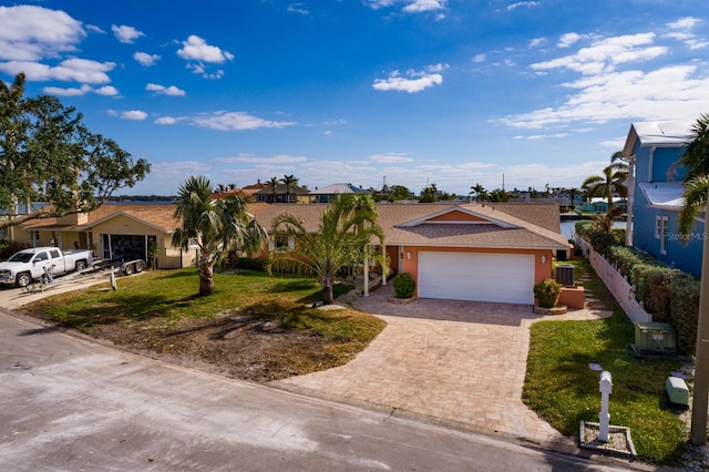 ranch-style home with a front lawn and a garage