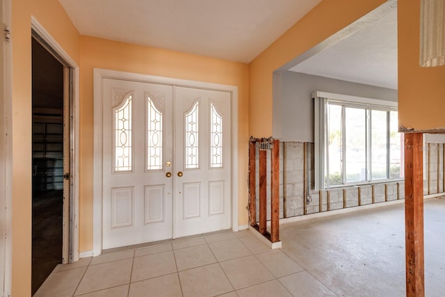 foyer entrance with light tile patterned floors