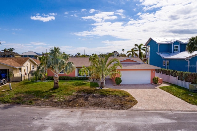 view of front of home featuring a front yard and a garage