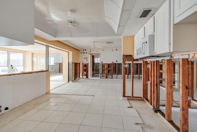 miscellaneous room with light tile patterned floors and ceiling fan