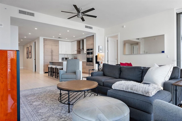 living room featuring ceiling fan and light wood-type flooring