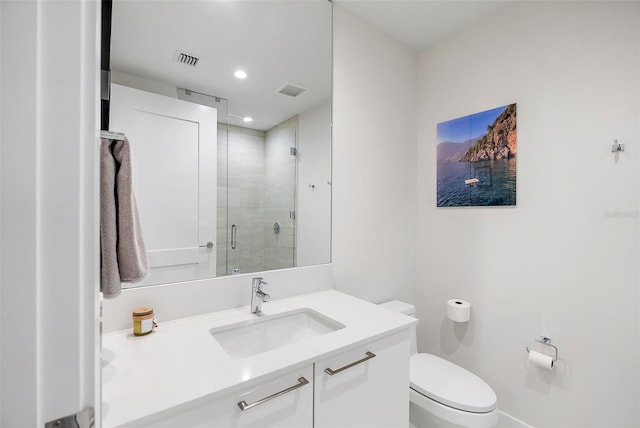 bathroom with a shower with door, vanity, and toilet