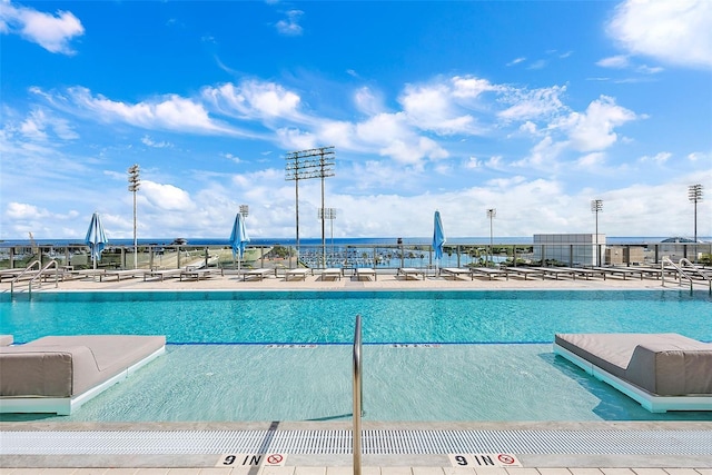 view of pool featuring a water view