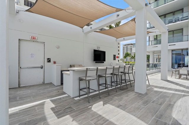 view of patio featuring exterior bar