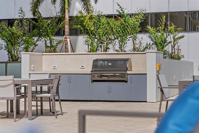 view of patio featuring area for grilling and a grill