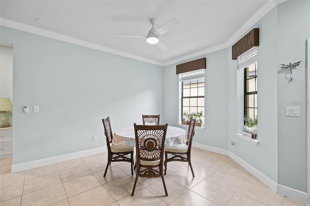 tiled dining area featuring ceiling fan and ornamental molding