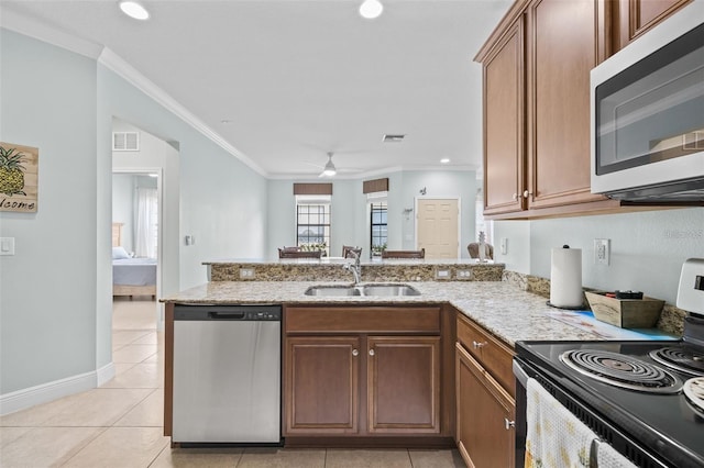 kitchen with appliances with stainless steel finishes, ceiling fan, ornamental molding, and sink