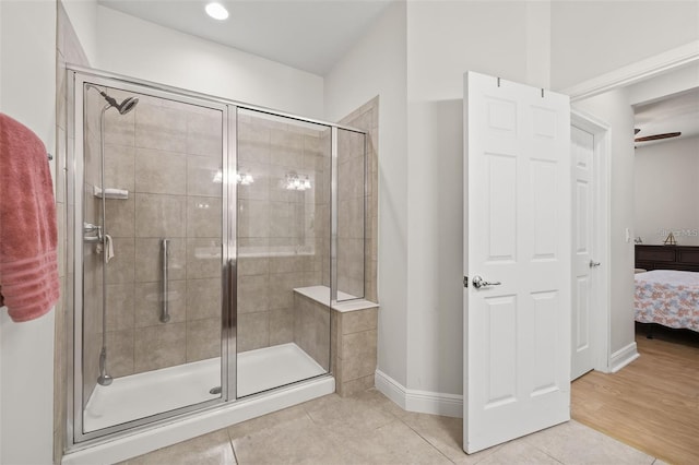 bathroom featuring wood-type flooring and a shower with shower door