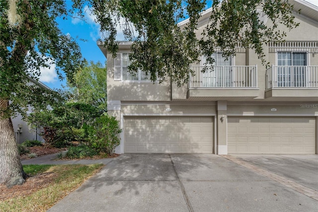 multi unit property featuring a balcony and a garage