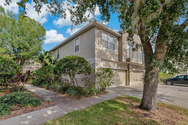 view of front of property featuring a balcony and a garage