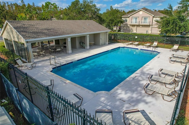 view of swimming pool featuring a patio area