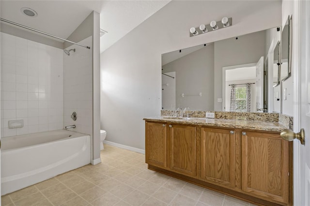 full bathroom featuring lofted ceiling, toilet, tiled shower / bath, and vanity