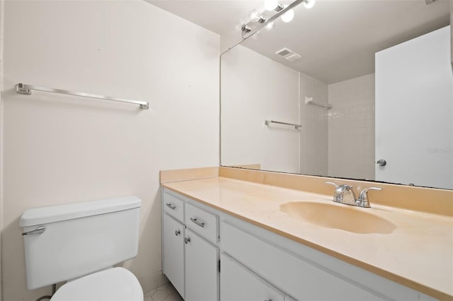 bathroom featuring tile patterned flooring, vanity, and toilet